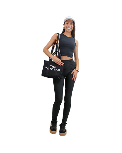 The women's junior model wears an all black look with the 
