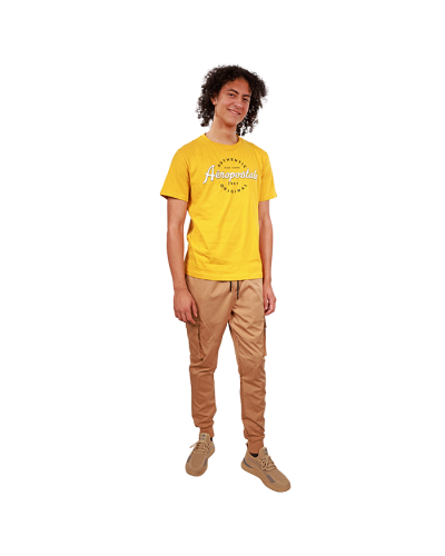 The male model wears our yellow "Aero" Short Sleeve Aeropostale Authentic Original Tee, khaki "SP" Nylon Cargo Pocket Jogger Pants, and beige "American Exchange" Ecko Athletic Sneakers.