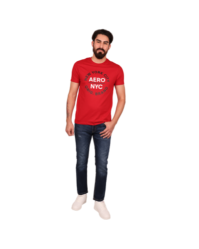 The male model wears the "AERO" Short Sleeve Red NYC Graphic Tee, "Rags + Rivets" Dark Wash Heavy Stitching Denim Straight Leg Jeans, and white "Air" Low Top Court Lace-up Pleather Athletic Sneakers.