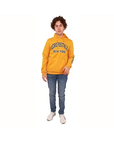 The male model wears the "Aero" Gold-Yellow Hooded Fleece Sweatshirt, "Aero" Medium Denim Slim Fit Jeans, and "CPC" Slip-on Athletic Sneakers.