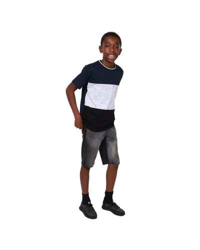 Pictured is a boy wearing a blue, grey, and black color block t-shirt with dark wash denim jean shorts and black athletic shoes.