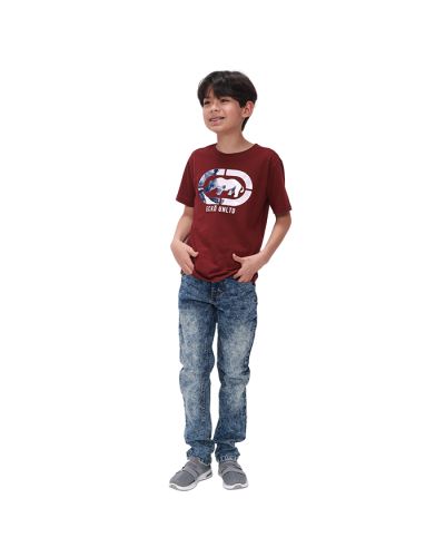 A boy wears a red "Ecko" Short Sleeve Rhino Logo Tee, acid-wash denim jeans, and grey athletic shoes.