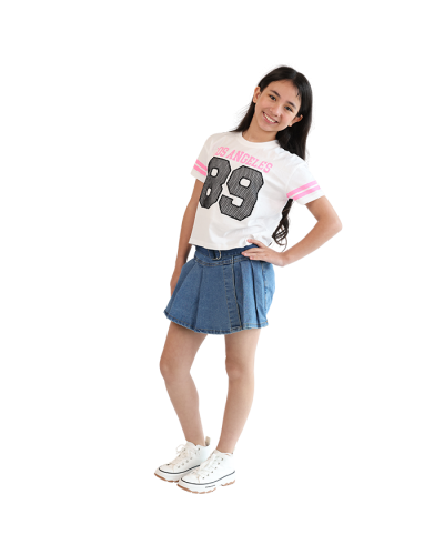 The girl model wears the white Los Angeles 89 "V & R" Short Sleeve Doleman Varsity Jersey Style Top, medium wash "Denim Diva" Pleated Belted Denim Skort, and the white "Lucky" High Top Platform Canvas Sneakers.