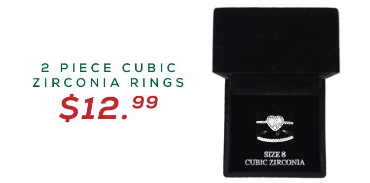 Image of a velvet box containing two rings, one a cubic zirconia set band and the other a silver plated ring with a large cubic zirconia heart.