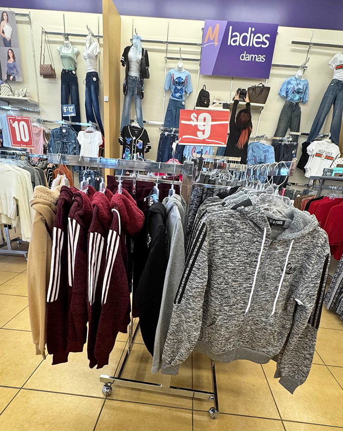 Pictured here is a Red Hot Sale rack with sweat shirts and sweat pants for $9 each