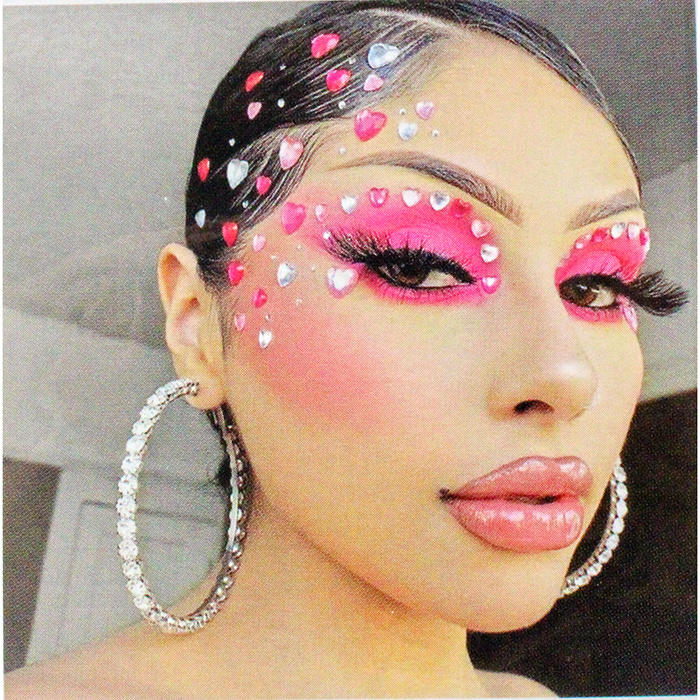 Women with hot pink makeup wearing the "UP" Multicolor/Clear Rhinestone Face Jewels.