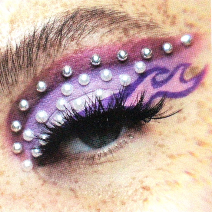 Purple flame makeup accessorized with the "UP" Multicolor/Clear Rhinestone Face Jewels.