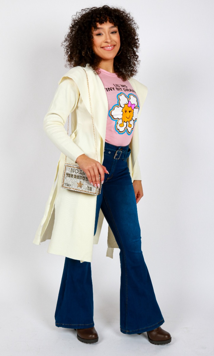 Pictured above is a My Melrose style by Sydney Cooper. She pairs the pink "Miss Popular" Short Sleeve Lil' Ms A Tiny Bit Dramatic t-shirt under the "Love Tree" Sweater Belted Trench Coat. The shirt is tucked into a pair of "Sweet Look" Dark Belted Flare Jeans set over brown "Top" 4" Lug Pleather Heeled Lace Up Booties.