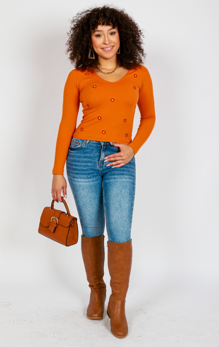 This retro inspired look by Sydney Cooper highlights the "FCT" Long Sleeve V-Neck Embroidered Knit Top over the "Blue Spice" 29" Light Wash Denim Skinny Jeans finished with the "Top Guy" 1 1/2 Stacked Stretch Calf Boots