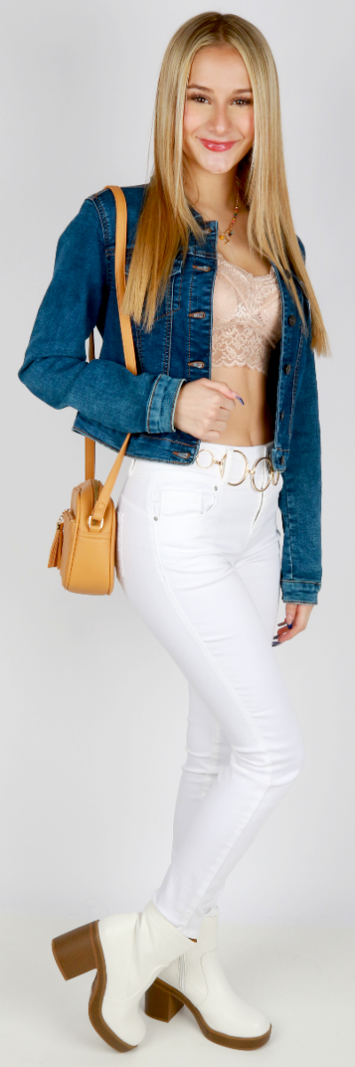 Chic western wear denim jacket over a khaki bralette, with white denim jeans and white heeled booties