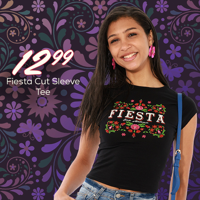 Young woman wearing a black short sleeve shirt with a floral fiesta logo on the chest